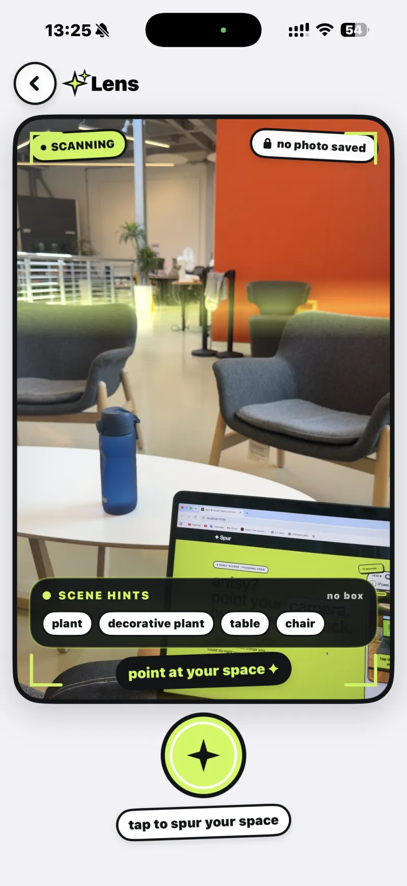 spur's Lens screen scanning a real lounge, chairs and a table and an orange wall, with scene hints reading plant, table, chair and a prompt to tap the spark